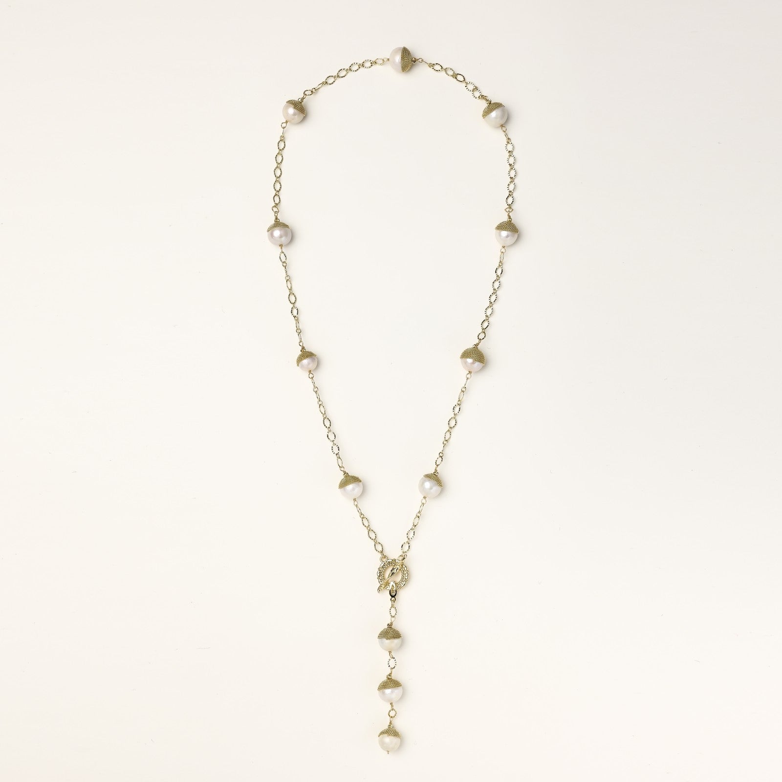 Long gold-plated lariat necklace featuring baroque pearls with metal caps arranged in elegant Y-shape design